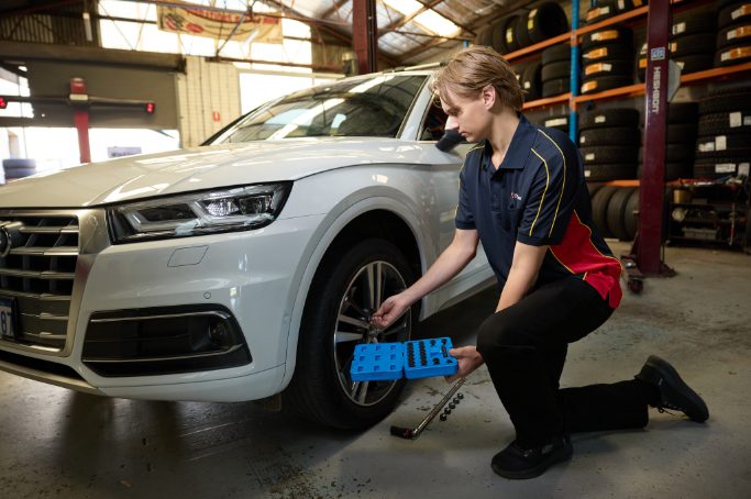  Tyrepower West Perth technician fitting tyres to a white Audi Q5 in the workshop