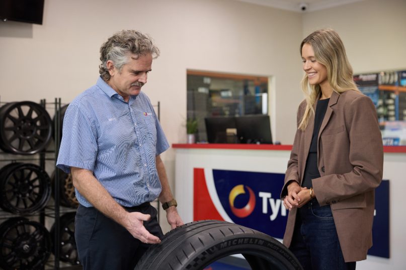  Customer choosing new tyres with staff at Tyrepower West Perth showroom near Leederville